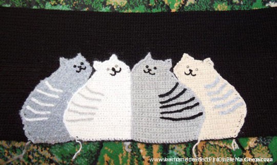 Here is the finished fabric from the front. Cats have embroidered faces, and sewn bead- eyes (beads on the light cats are silver and black on the dark ones), embroidered strips on the back. Cats are trimmed along the contour with stem stitch.